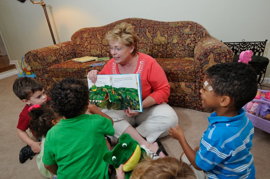 Teacher reads to a group of students in a Family Child Care Home