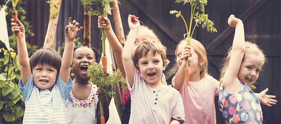 Children holding vegetables