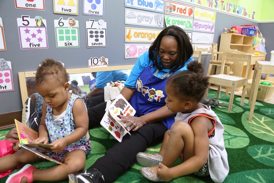 a teacher reads to young learners