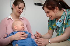 2006 Content Provided by: Judy Schmidt This photograph shows an infant held by his mother, receiving an intramuscular vaccination in the thigh. Vaccinations are most often given to optimize the immune response of the vaccine and reduce the adverse reactions in and around the injection site. Infants and young children should be vaccinated in the anterolateral aspect of the thigh. It is a healthy well developed muscular area and has a low risk of neural, vascular and tissue injury making it the safest site of injection.