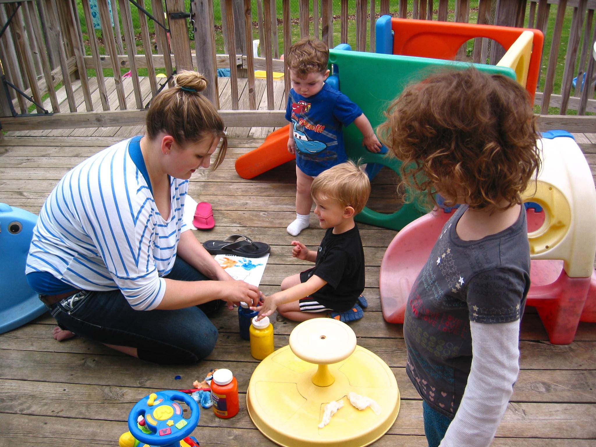 children play with paint outside