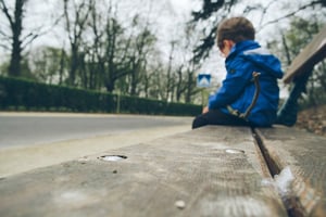 sad boy on a bench