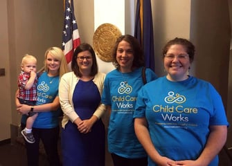 Families pose outside their Senator's office