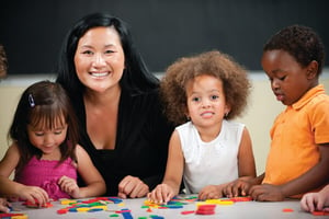 Preschoolers in a classroom with their teacher.