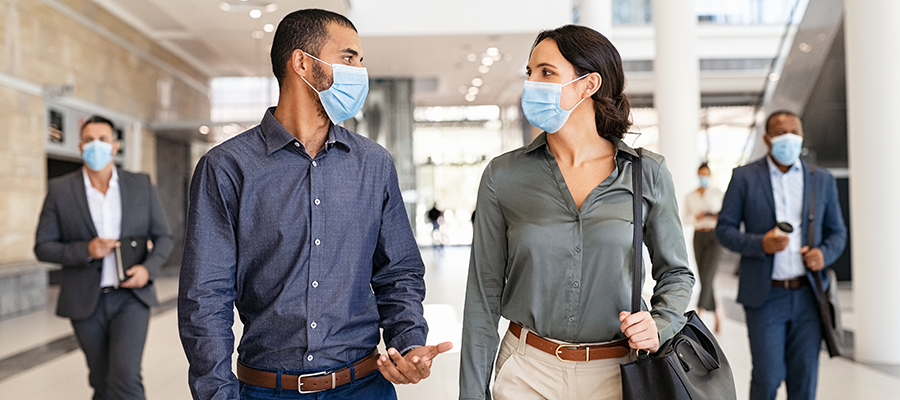 colleagues walking wearing masks