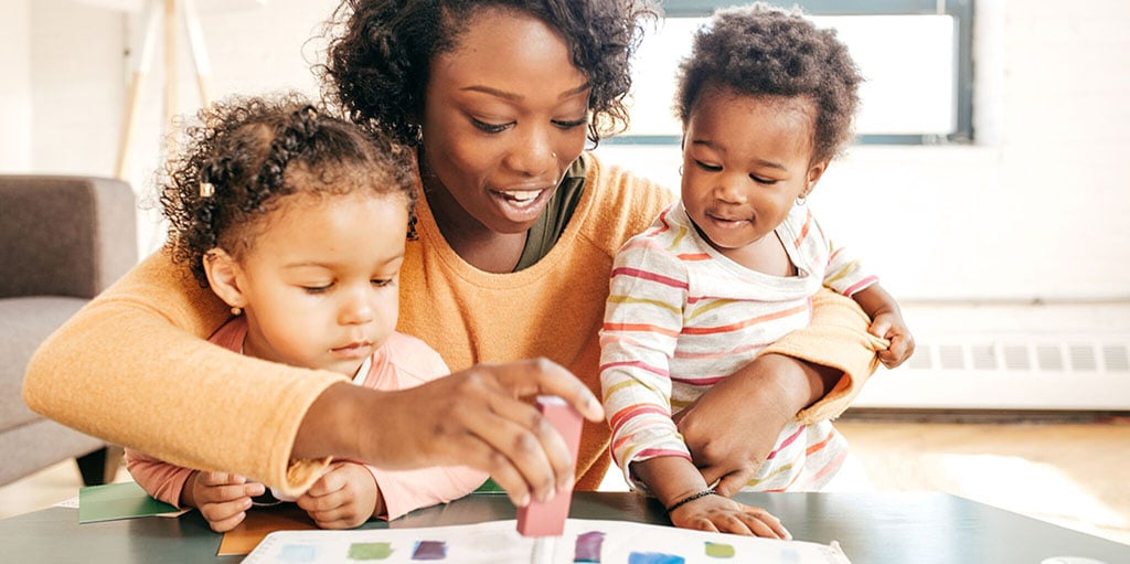 a mom plays with her young children