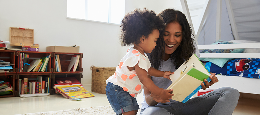 mom and daughter reading in nursery