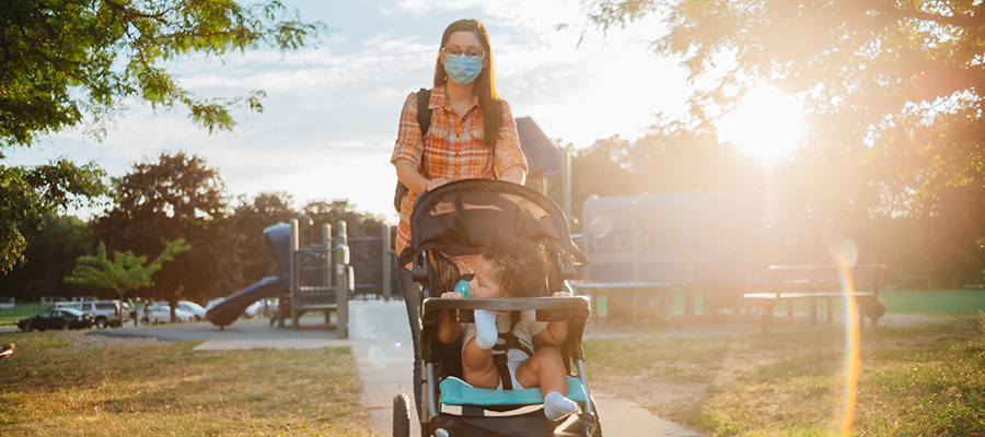 mom and son walking in park