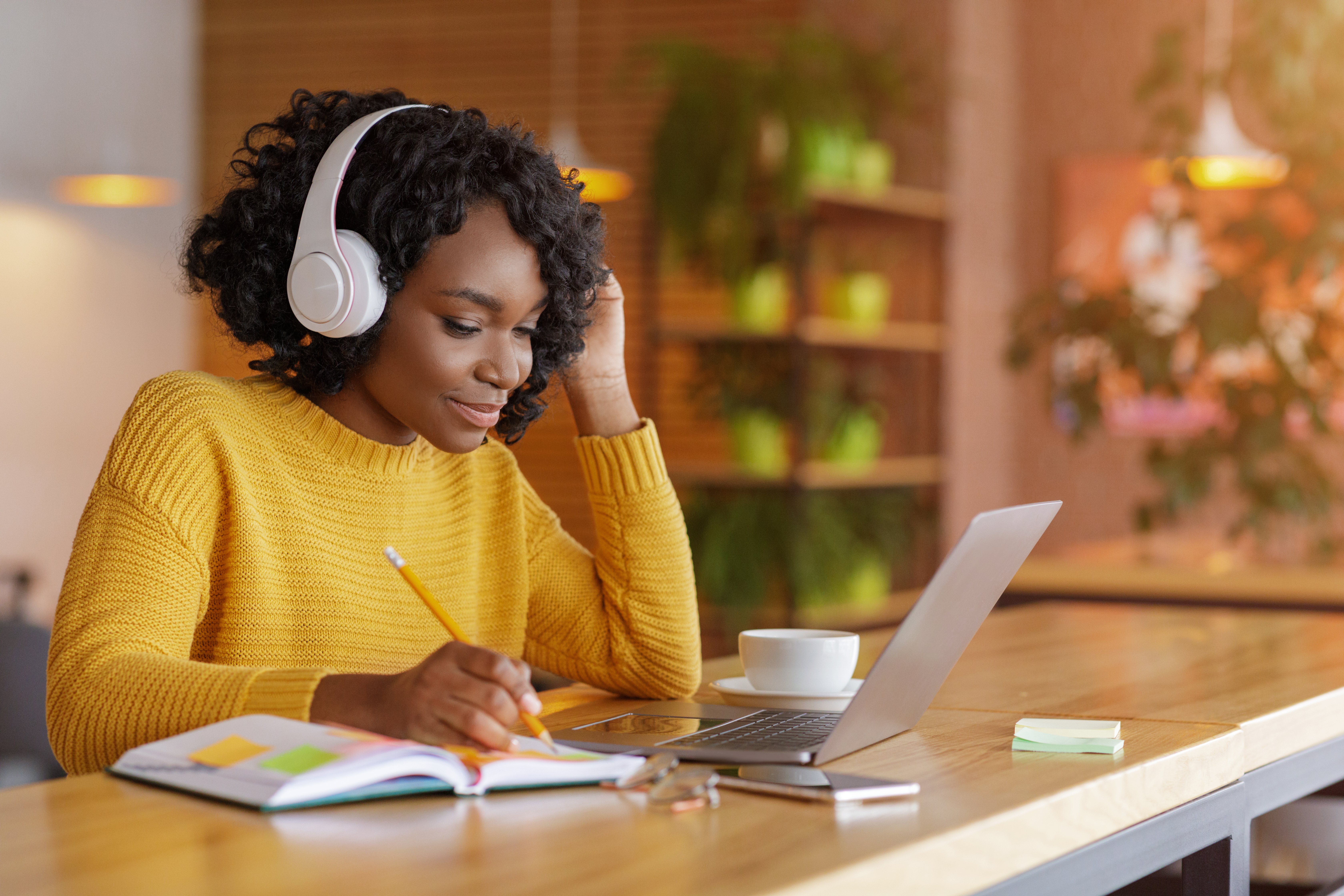 smiling-black-girl-with-headset-studying-online-us-ZB9E52C