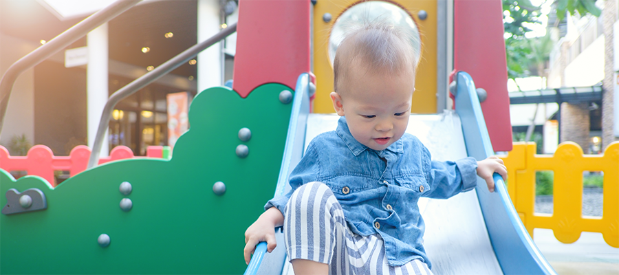 young child coming down slide